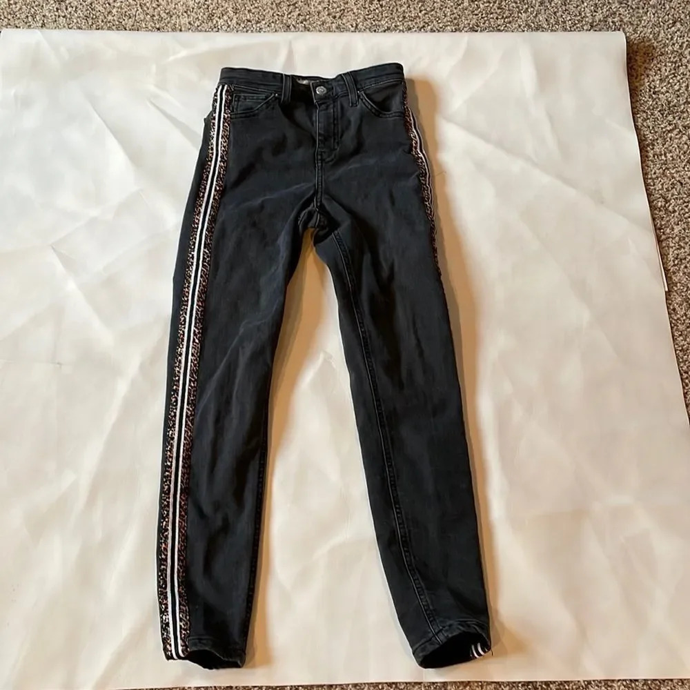 TOPSHOP woman’s black jeans w/ leopard print all the waydown the side of jeans